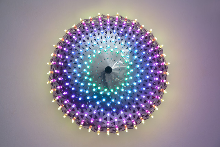A wall-mounted lamp featuring a pixel LED light, showcasing modern design and functionality in a stylish setting.