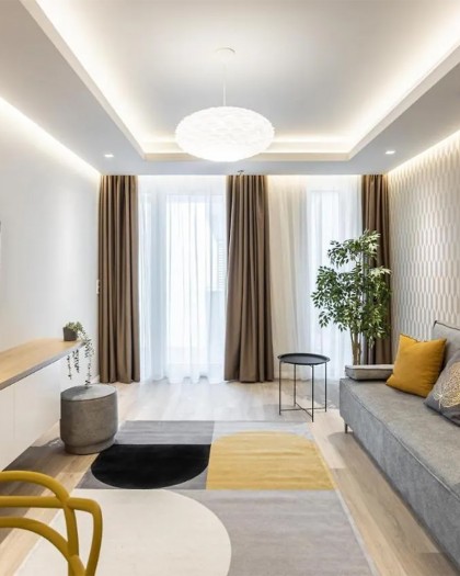 Clean geometric pendant light above hotel room seating area