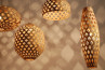 Four stylish hanging lamps, each with a unique hexagonal bamboo design, perfect for modern interior illumination.