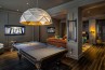 Sun Chandelier Gold 140, in hotel game room, light over pool table, 