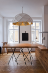 Sun Chandelier Gold large pendant light, gold inside, lights off, in studio restaurant, above dining table,